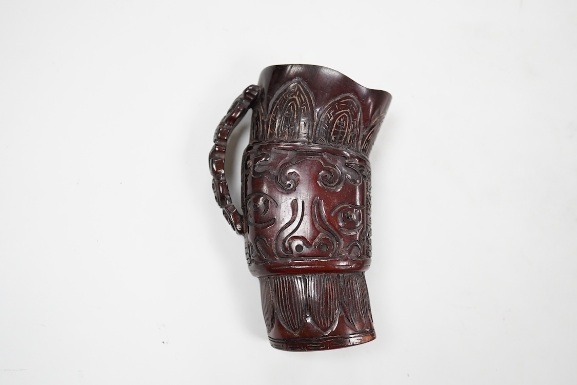 A Chinese carved horn jug, 11cm high